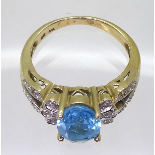 793 - A 9ct gold blue topaz and diamond accent ring, size L, weight 4.1gms