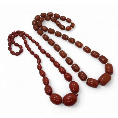 830A - Two strings of red amber beads1 (left): weight 89.6gms2 (right): weight 154.5gms