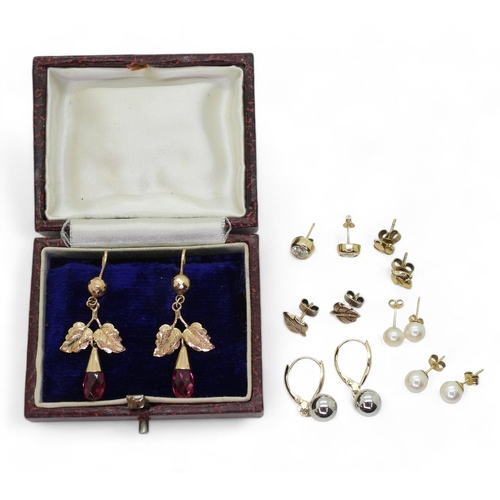 834 - A pair of 14ct bi-coloured gold earrings, weight 1.2gms, together with a pair of yellow metal red gl... 