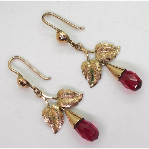 834 - A pair of 14ct bi-coloured gold earrings, weight 1.2gms, together with a pair of yellow metal red gl... 