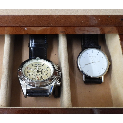 835 - Three boxes of fashion watches, to include a motorized self winder for automatic watches, a two tier... 