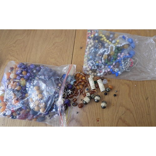 836 - A large collection of loose beads to include glass, faux amber, wood and metal vintage beads