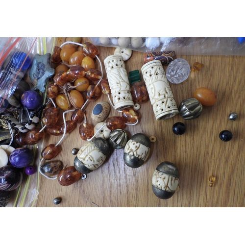 836 - A large collection of loose beads to include glass, faux amber, wood and metal vintage beads