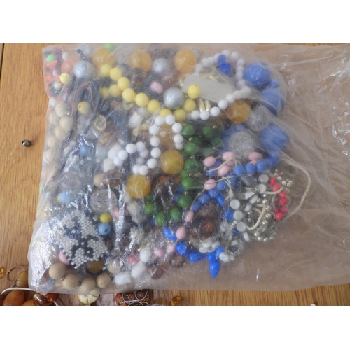 836 - A large collection of loose beads to include glass, faux amber, wood and metal vintage beads