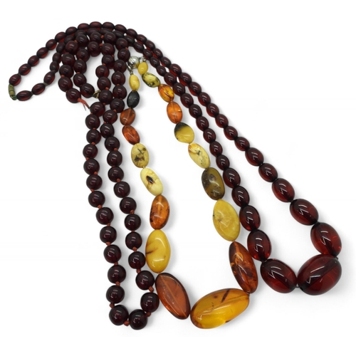 840 - A string of mixed colour amber beads together with two strings of cherry amber coloured beads (one t... 