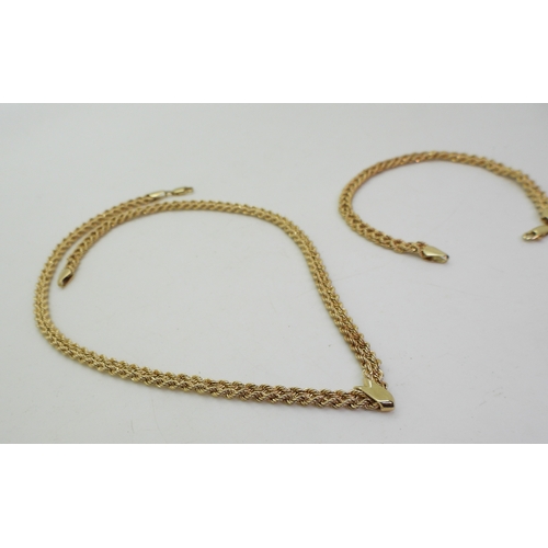 2708 - A NECKLACE & BRACELET SET made from rope chain, with a decorative 'V' shape necklace with matchi... 