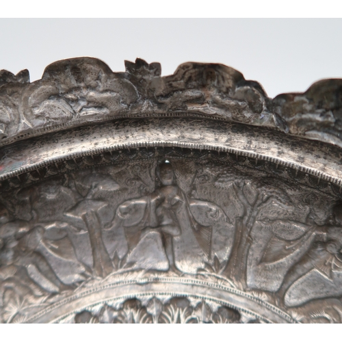 2531 - AN INDIAN SILVER FOOTED BOWLchased in high relief, depicting aspara amongst trees, the decoration co... 