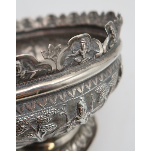 2531 - AN INDIAN SILVER FOOTED BOWLchased in high relief, depicting aspara amongst trees, the decoration co... 