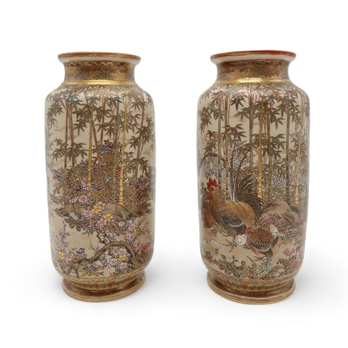 2412 - A PAIR OF SATSUMA CYLINDRICAL VASES Painted with game birds amongst bamboo and blossoming plants, se... 