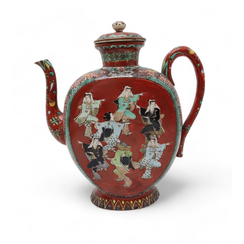 2415 - A KUTANI STYLE TEA KETTLE Painted with dancing figures on a red ground surrounded by demonic masks, ... 