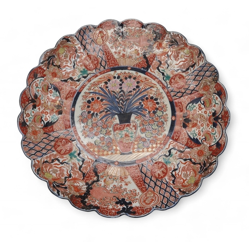 2420 - A LARGE IMARI CHARGER Painted with panels of flowers, Ho-o birds, diaper and mon decoration, 58cm di... 