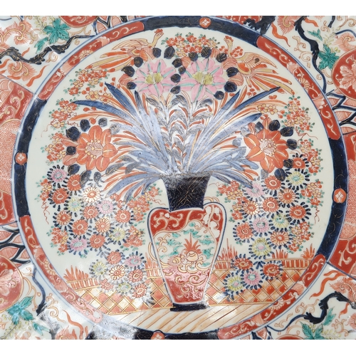 2420 - A LARGE IMARI CHARGER Painted with panels of flowers, Ho-o birds, diaper and mon decoration, 58cm di... 