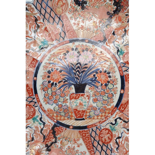 2420 - A LARGE IMARI CHARGER Painted with panels of flowers, Ho-o birds, diaper and mon decoration, 58cm di... 