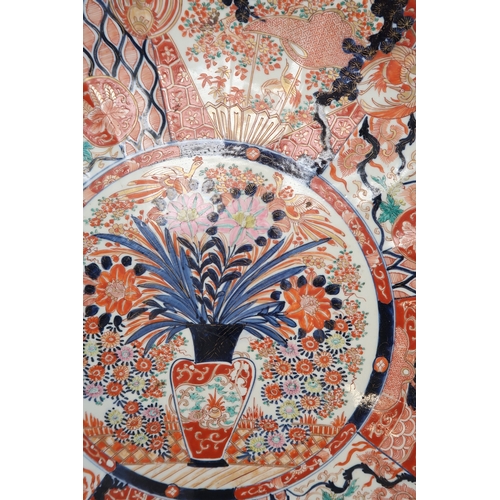 2420 - A LARGE IMARI CHARGER Painted with panels of flowers, Ho-o birds, diaper and mon decoration, 58cm di... 