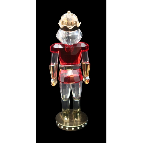 2239 - A SWAROVSKI CRYSTAL FIGURE OF A NUTCRACKERin clear and coloured crystal with gilded metal mounts, 12... 