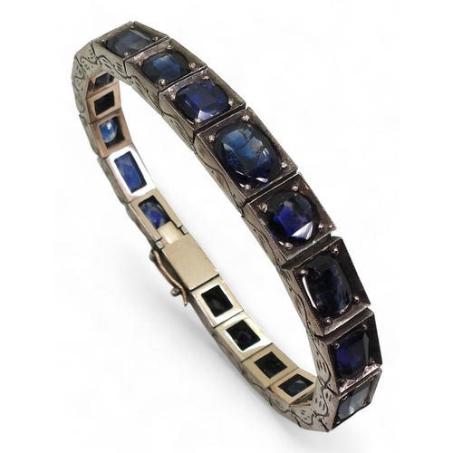 2721 - A SAPPHIRE BRACELETset with mixed cut sapphires tapering in size roughly from 7.8mm x 10mm to 5.5mm ... 