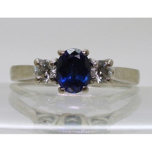 2723 - A SAPPHIRE & DIAMOND THREE STONEset in 18ct white gold the central sapphire is approx 7mm x 5.4m... 