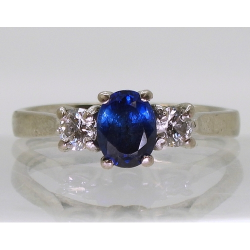 2723 - A SAPPHIRE & DIAMOND THREE STONEset in 18ct white gold the central sapphire is approx 7mm x 5.4m... 