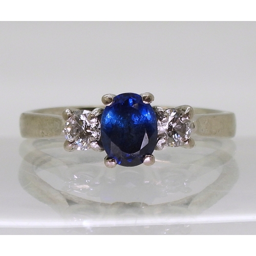 2723 - A SAPPHIRE & DIAMOND THREE STONEset in 18ct white gold the central sapphire is approx 7mm x 5.4m... 