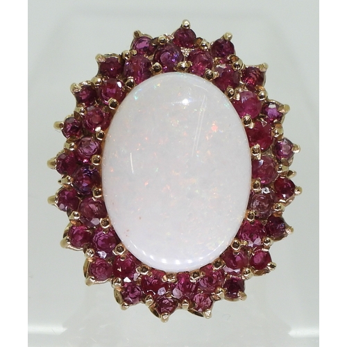 2725 - RUBY & OPAL RINGthis large statement ring, is set with a white opal cabochon of approx 20mm x 15... 