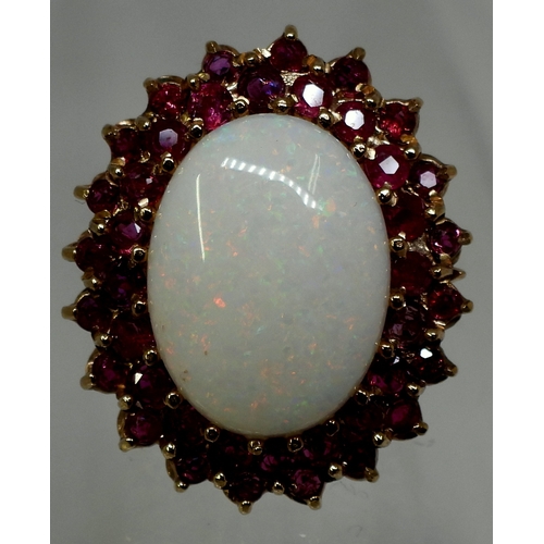 2725 - RUBY & OPAL RINGthis large statement ring, is set with a white opal cabochon of approx 20mm x 15... 