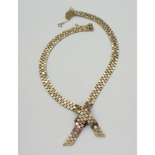 2736 - A RETRO NECKLACE made in tricolour 9ct gold, bearing the Birmingham hallmarks for 1976, set with a d... 