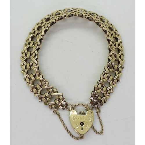 2737 - A DECORATIVE BRACELETmade in 9ct gold with cross and baton shaped links and a heart shaped clasp, ha... 