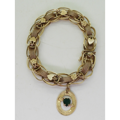 2741 - A FANCY CHAIN BRACELET14k gold woven with sold links and ribbon chain, with applied heart and flower... 