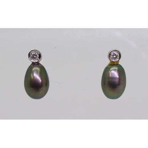 2744 - DIAMOND EARRINGSthe first pair in 18ct white gold set with drop shaped black pearls 9mm long, enhanc... 