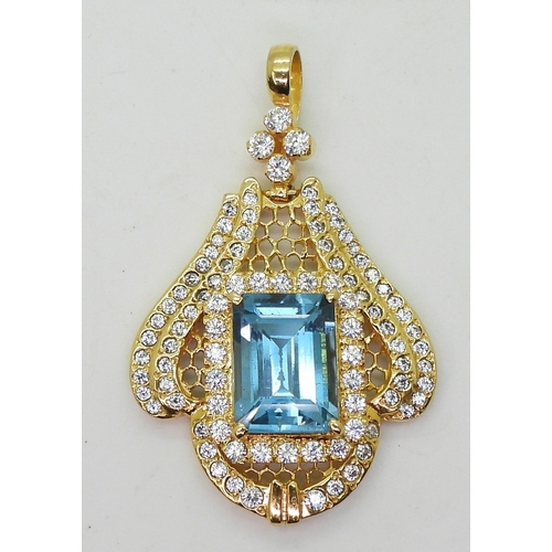 2746 - A BLUE TOPAZ SUITEcomprising of a pendant further set with cubic zirconia, stamped SA 18K to the bac... 