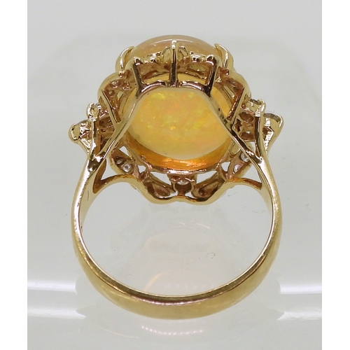 2747 - AN OPAL STATEMENT RINGset with a 18.5mm x 13mm x 5.6mm cabochon jelly opal, the 14k gold mount is fu... 