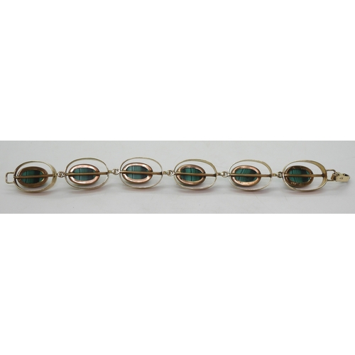 2754 - A RETRO BRACELETmade in South Africa, the oval links are set with malachite, stamped 9ct to both the... 