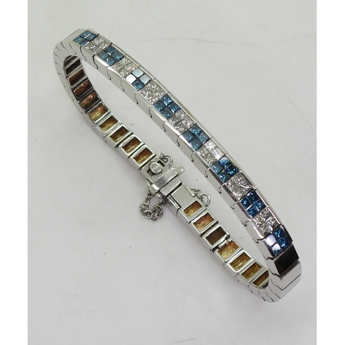 2755 - A DIAMOND BRACELETset with teal and white coloured princess cut diamonds, with an estimated approxim... 