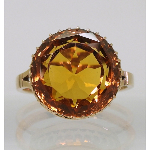 2756 - A CITRINE RINGa statement piece with a 14mm orange citrine in a multi clawed galleried mount, finger... 