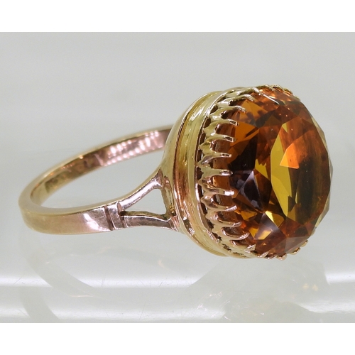 2756 - A CITRINE RINGa statement piece with a 14mm orange citrine in a multi clawed galleried mount, finger... 