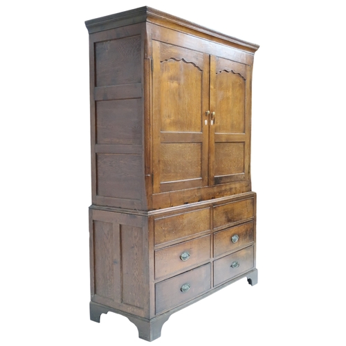 2024 - A LATE 19TH/EARLY 20TH CENTURY OAK LINEN PRESS/WARDROBE with cornice over pair of panelled door... 