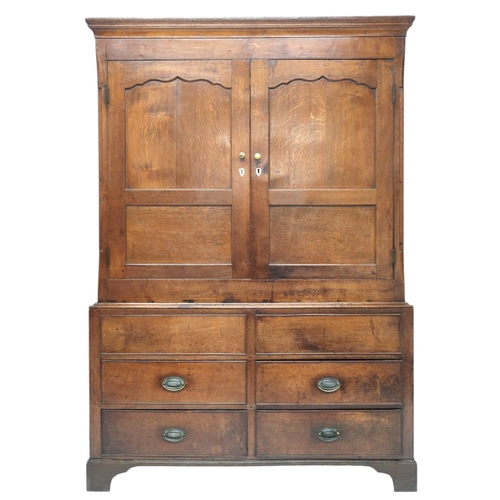 2024 - A LATE 19TH/EARLY 20TH CENTURY OAK LINEN PRESS/WARDROBE with cornice over pair of panelled door... 