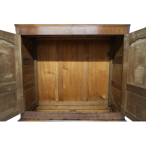 2024 - A LATE 19TH/EARLY 20TH CENTURY OAK LINEN PRESS/WARDROBE with cornice over pair of panelled door... 