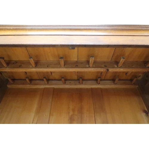 2024 - A LATE 19TH/EARLY 20TH CENTURY OAK LINEN PRESS/WARDROBE with cornice over pair of panelled door... 