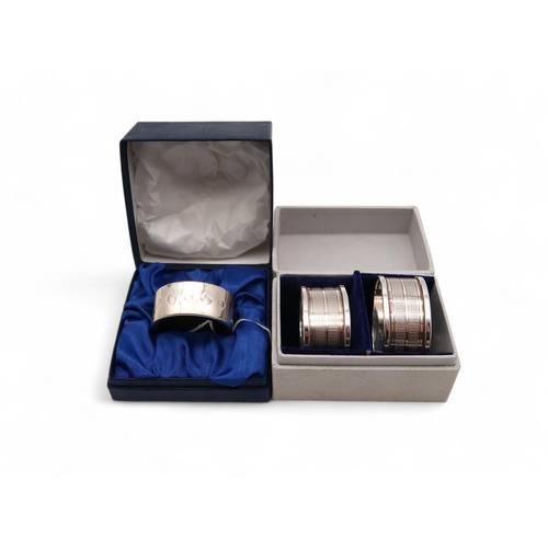 388 - A pair of silver napkin rings, Birmingham 1961, and a silver bottle ring, by B & Co, Birmingham,... 