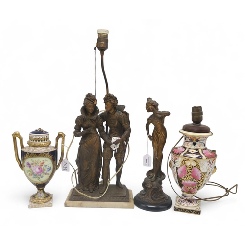 203 - A spelter figure of a maiden, a spelter table lamp modelled as a couple and two ceramic urns