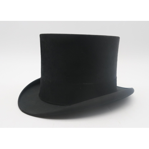 506A - A silk top hat by Carswell of Glasgow, approx. 7 1/8 - 7 1/4 in size, measuring approx. 20.4cm front... 