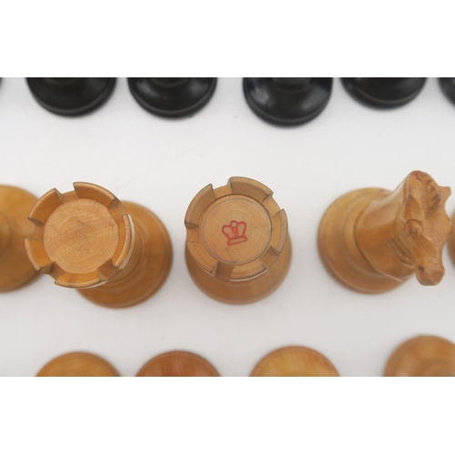 511 - A boxwood and ebony chess set (non-weighted), with kingside knights and rooks stamped with crown dev... 