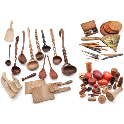 515 - A large collection of treen, to include butter pats, spiral twist-handled ladles, glove stretchers i... 