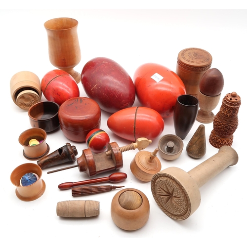 515 - A large collection of treen, to include butter pats, spiral twist-handled ladles, glove stretchers i... 