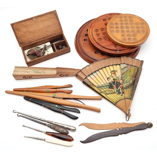 515 - A large collection of treen, to include butter pats, spiral twist-handled ladles, glove stretchers i... 