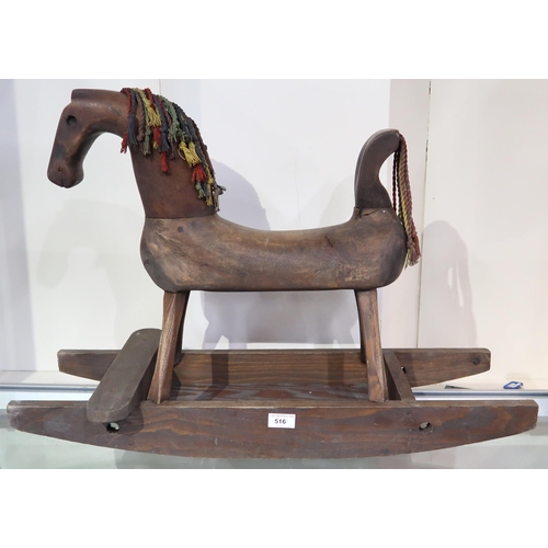 516 - A naive Folk Art rocking horse, the hollow body serving as a money bank, the rockers measuring appro... 