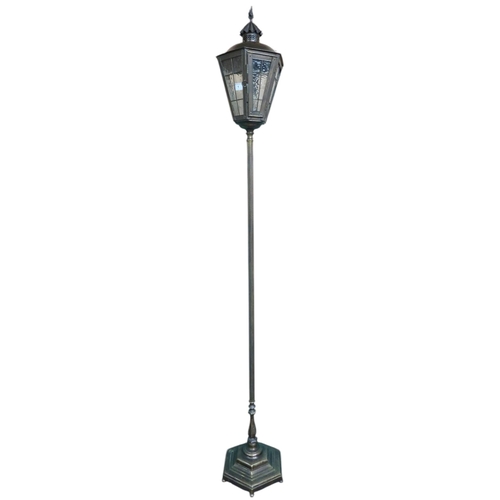 1 - A 20th century metallic standard lamp in the form of a 19th century street lantern, 180cm high 