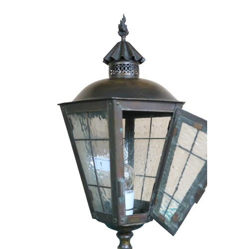 1 - A 20th century metallic standard lamp in the form of a 19th century street lantern, 180cm high 