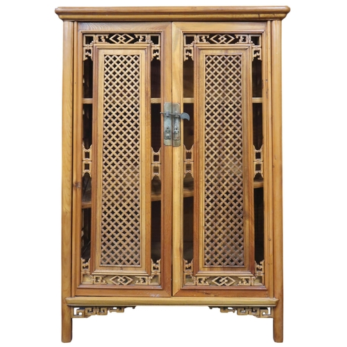 10 - A 20th century Oriental hardwood side cabinet with stylistic pierced doors and sides on shaped suppo... 